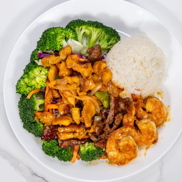 Hibachi Express plate with chicken, steak, shrimp, broccoli, and white rice.